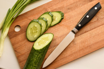 cucumber and knife on cutting board