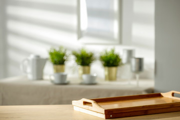 Mineral water on a wooden table in the morning sunlight with free space for an advertising product
