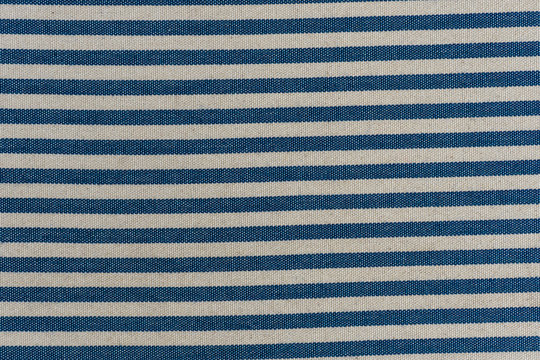 Nautical textile texture for background. Close up of a marine textile texture with blue and white stripes.