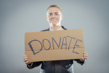 man holding Cardboard text a donate