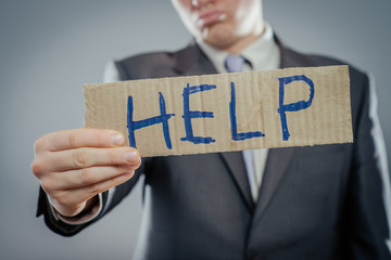 Man holding paper with help text