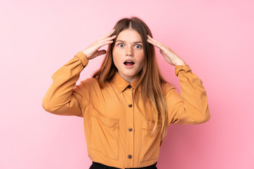 Ukrainian teenager girl over isolated pink background with surprise expression