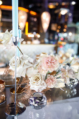 banquet table is decorated with plates, cutlery, glasses, candles and flower arrangements