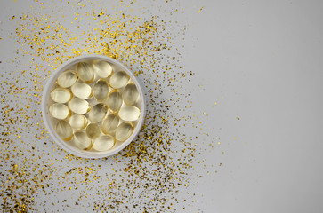 Vitamin D3 gelatin capsules on a white background. The fat-soluble solar vitamin cholecalciferol...