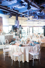 banquet table is decorated with plates, cutlery, glasses, candles and flower arrangements