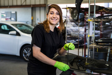 Happy female car mechanic