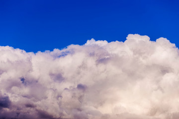 Large multi-colored clouds on a blue sky. Dark storm clouds. overcast sky