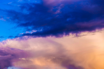 Naklejka na ściany i meble Multi-colored thundercloud at sunset. Beautiful sky