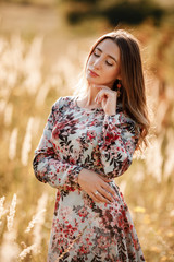 Portrait of beautiful young girl outdoors in spring. young girl in a field