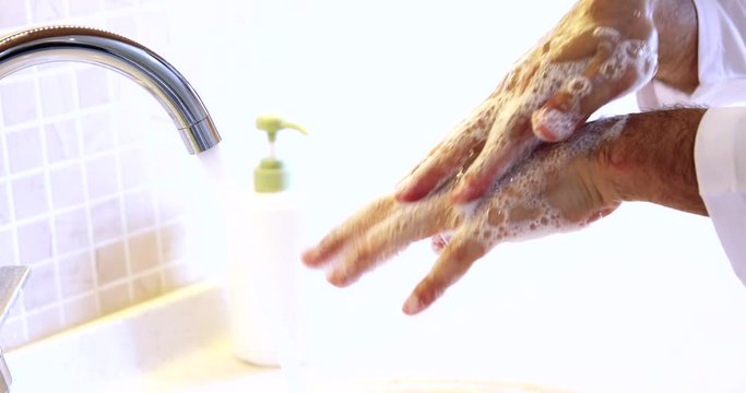 Man washing hands properly with soap to be protected for Coronavirus 2019-nCoV pandemic epidemic infection. Doctor shows how to wash hands properly.