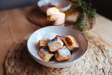 Fototapeta na wymiar Cottage cheese pancakes with sour cream, jam and Christmas decoration.