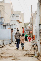 Father and son walking down the road in Agra, India