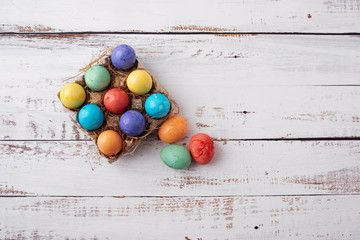 Brightly Colored Easter Eggs on a White Wood Table