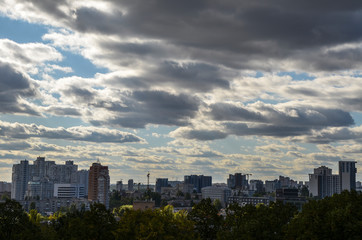 View of new buildings in residential areas surrounded by green trees and amazing blue sky with clouds in the capital of Ukraine Kyiv