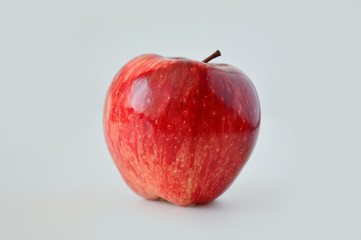 Very beautiful red fresh apple on a white background isolate. Minimalism.