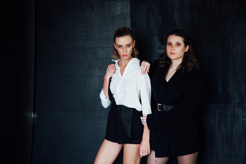 Two beautiful fashionable female brunette girlfriends and blonde together