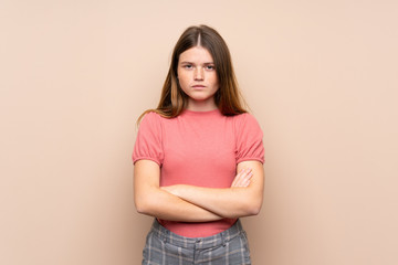 Ukrainian teenager girl over isolated background keeping arms crossed