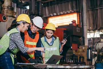 Asian engineer or technician man foreman training female trainee using program or system in...