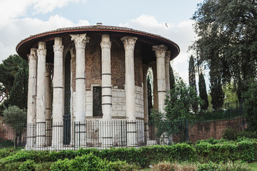 Fototapeta na wymiar Roman temple in beautiful day. Ruins and Archaeological remains Rome, Italy.