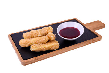 Camembert cheese fried in batter and breadcrumbs with cranberry sauce. Soft and viscous inside.On a wooden board on a white background.