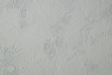 Background in the form of a surface with gray plaster. Horizontal orientation, selective focus.