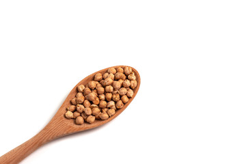 Dry organic chickpeas in a wooden spoon isolated on white background with space. Top view. 
