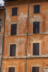 orange wall with  windows, italy