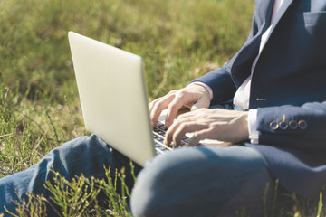 Work outside concept. Soft focus laptop in nature background. Ecology travel and work outside office concept.