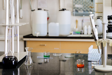 Samples in lab glassware surrounded by lab equipment in hospital laboratory ready for testing and research for covid 19 or coronavirus vaccination