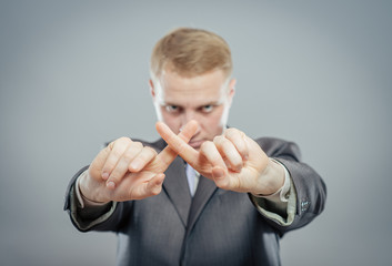 man hands crossing fingers forming an x