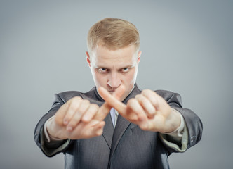 man hands crossing fingers forming an x