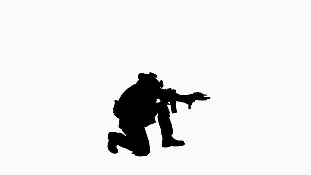 Silhouette Soldier sits down for aiming and shooting with rifle.