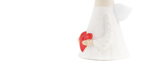 Ceramic angel figurine in a long white robe holds a big red heart with both of his very detailed...