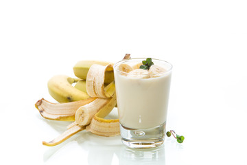 tasty homemade yogurt with bananas in a glass isolated on white background