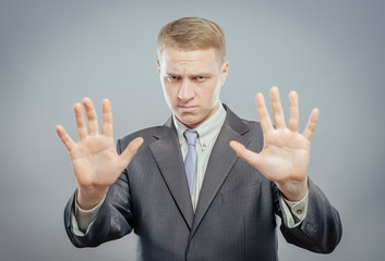 Afraid man in defense attitude gesturing stop with hands