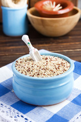 Organic quinoa grains in blue ceramic bowl, Gluten free. Concept Healthy food. Seeds of Chenopodium quinoa
