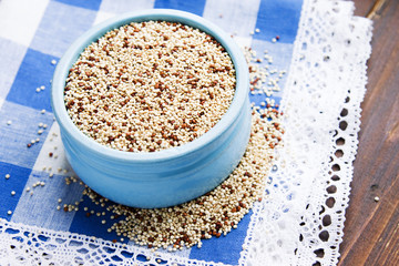 Organic quinoa grains in blue ceramic bowl, Gluten free. Concept Healthy food. Seeds of Chenopodium quinoa
