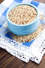 Organic quinoa grains in blue ceramic bowl, Gluten free. Concept Healthy food. Seeds of Chenopodium quinoa