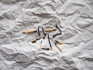 dead matches on crumpled paper