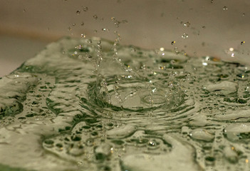 falling drops of water to the surface