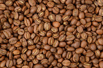 Aromatic roasted coffee beans background. Texture top view.