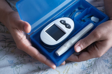 young women test blood sugar for diabetes, close up 
