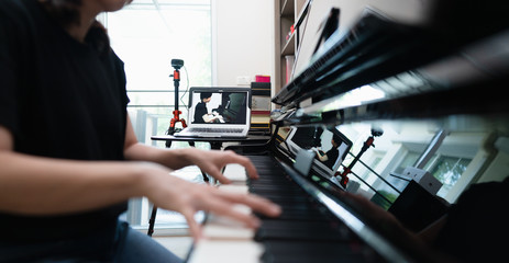 Online class or E-learning piano lessons during Coronavirus spread out or covid-19 crisis situation, students pupils having piano online class solution or alternative way for social distancing.