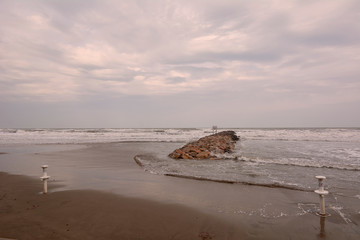 Fototapeta premium Lonely beach with groyne, a stormy day