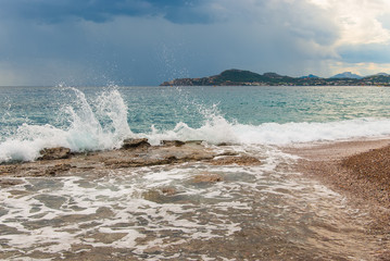 Wave splash on stones on the coast