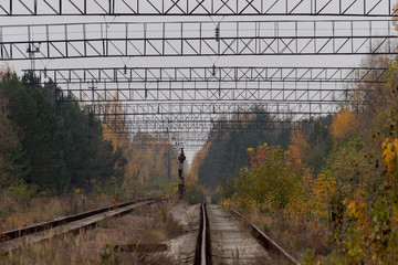 Empty abandoned train tracks leading into the distant vanishing point in Pripyat, Chernobyl...