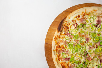 italian pizza with bacon and onions on a white plate