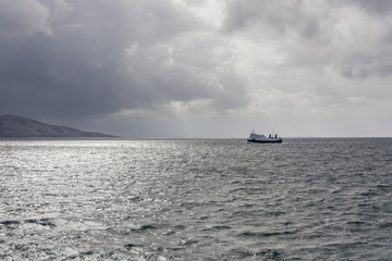 ship sailing on the blue water of the norwegian fjords in polar day, midnight sun