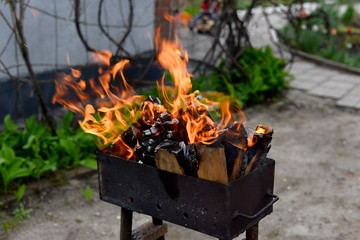 fire burning in a barbecue outdoors
