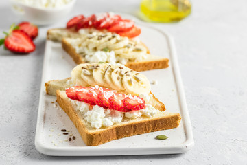 Strawberry banana rocotta honey toasts. Selective focus, copy space.